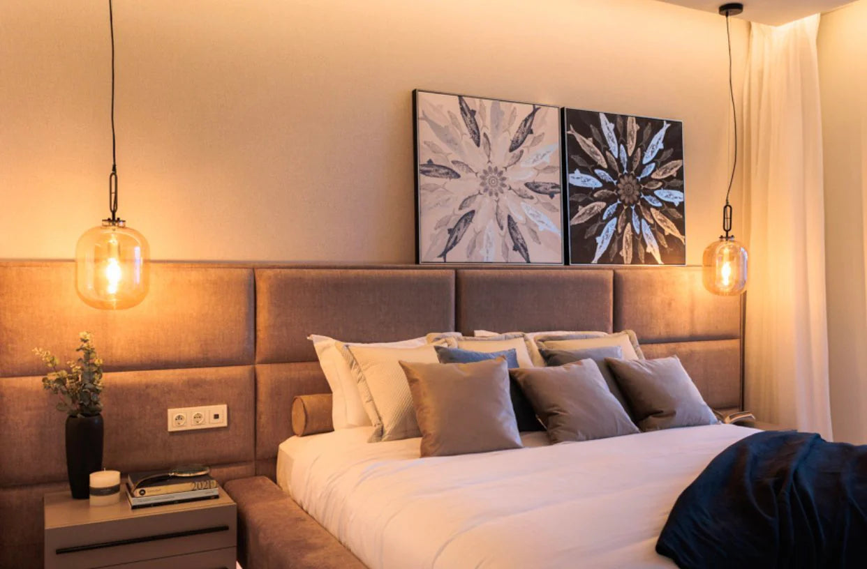 Modern bedroom with a bed, nightstands, and wall art.